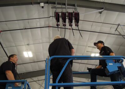 NW Pump engineers installing overhead air compressors on a scissor lift