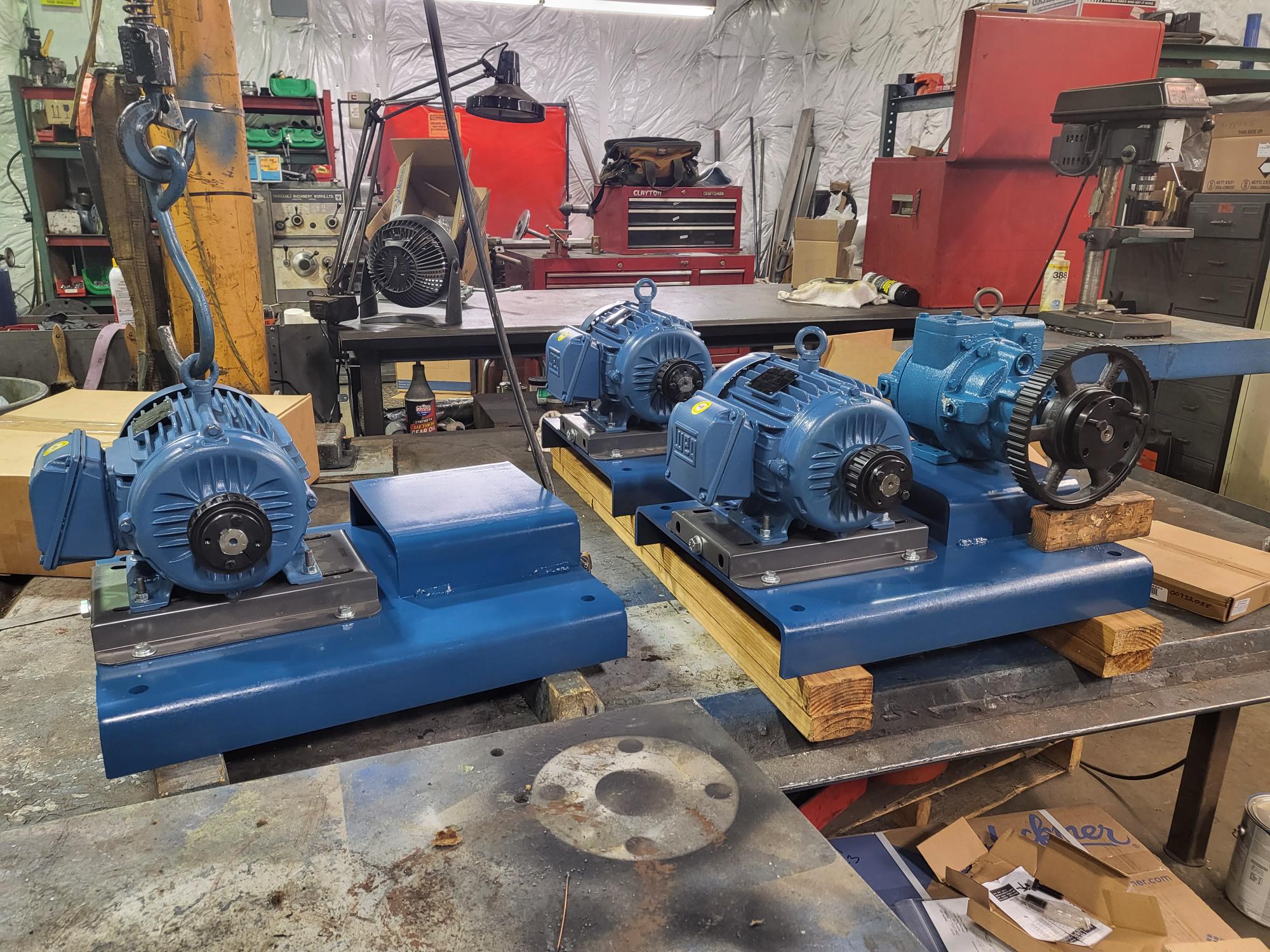 Four centrifugal pumps sitting on a work bench